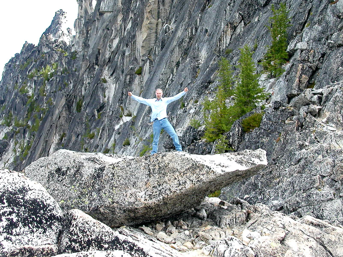 larry standing on a balanced flat rock