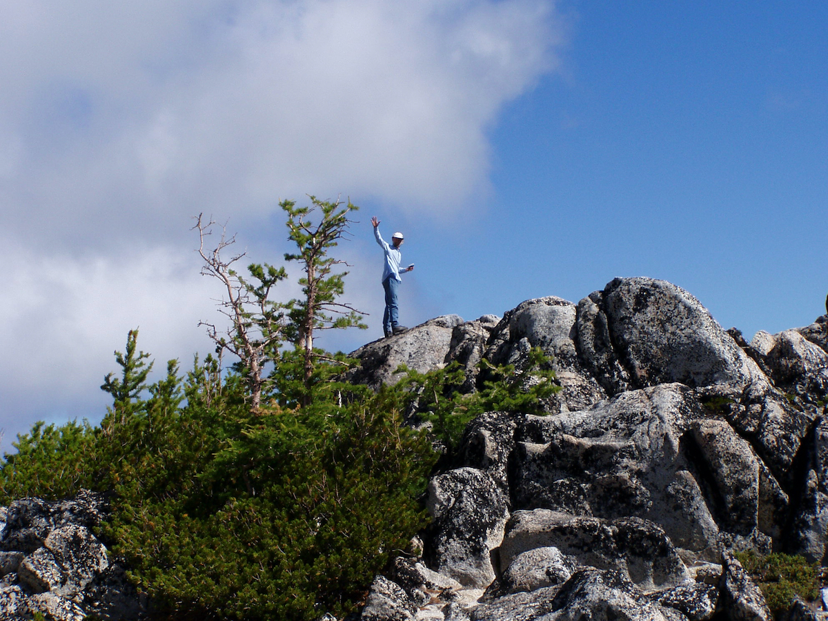 looking up to a ridge with Larry on top