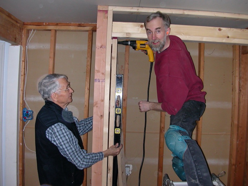 Leslie holding level, Larry setting stud
