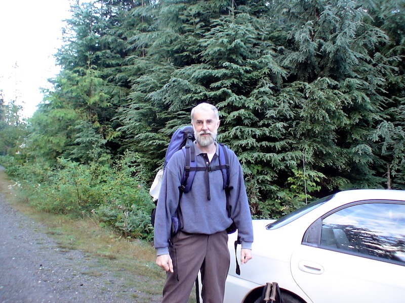 standing with backpack by car at tralhead