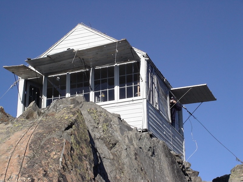 square cabin with lifted shutters