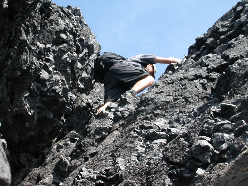 looking up to David climbing the textured rocks