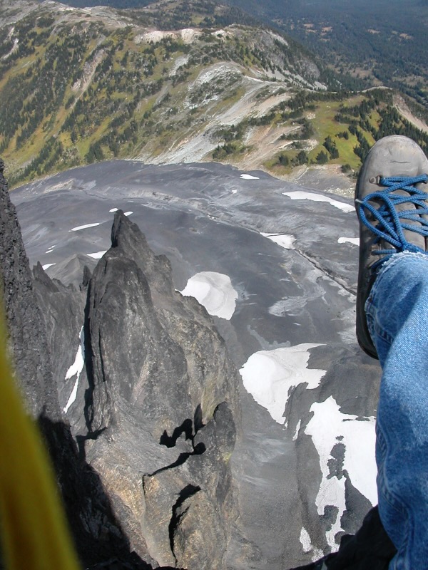 feet hanging over edge and empty space below