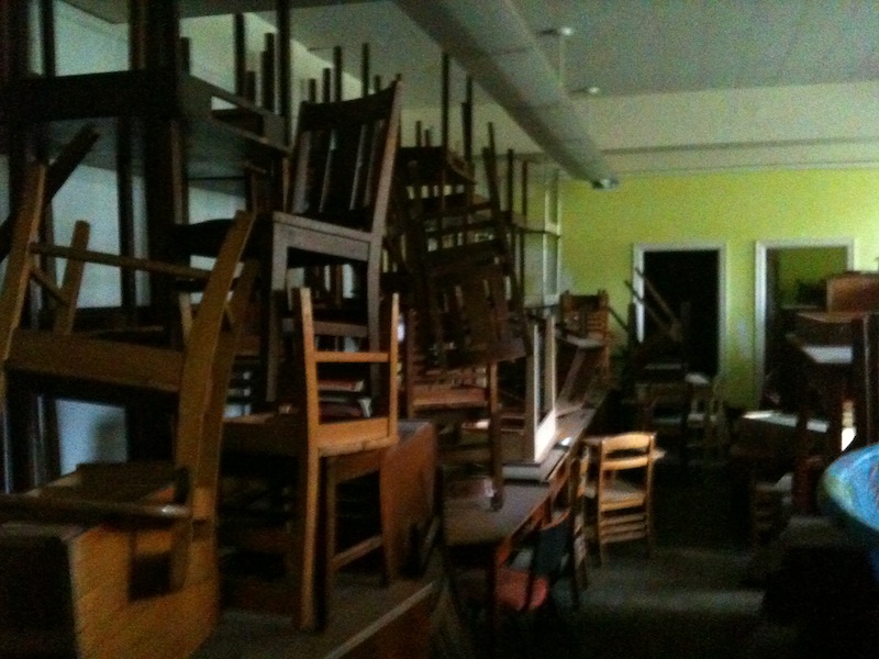 wooden chairs stacked to ceiling