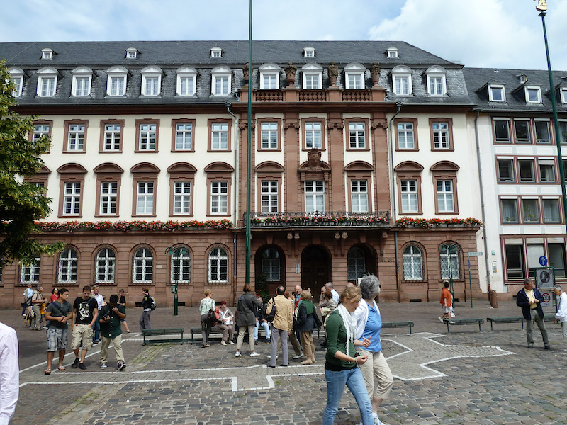 Four story building with stone, flowers