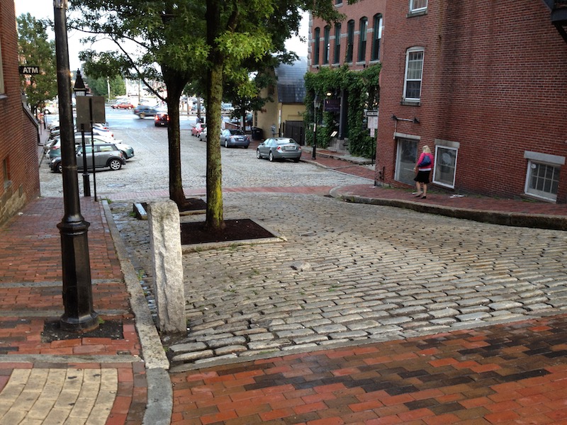 Brick sidwalk and cobbled street