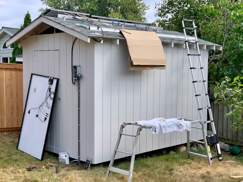 Solar panels being installed on the shed