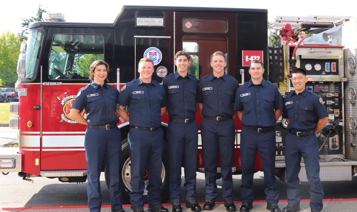 six new firefighters in front of fire engine