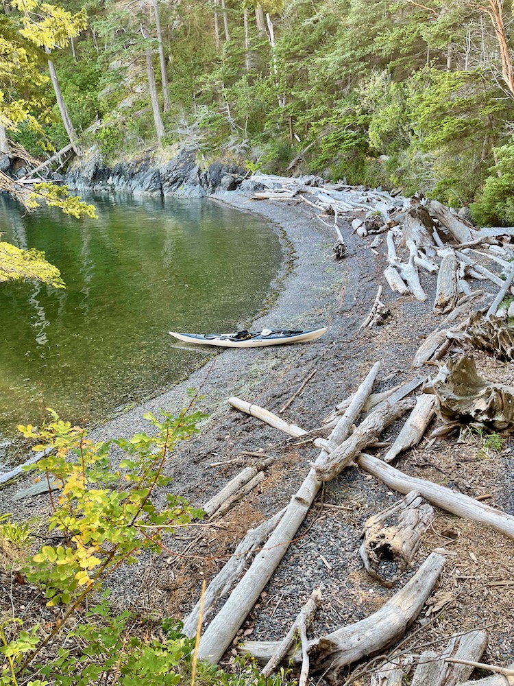 gravel cove with kayak pulled up on shore