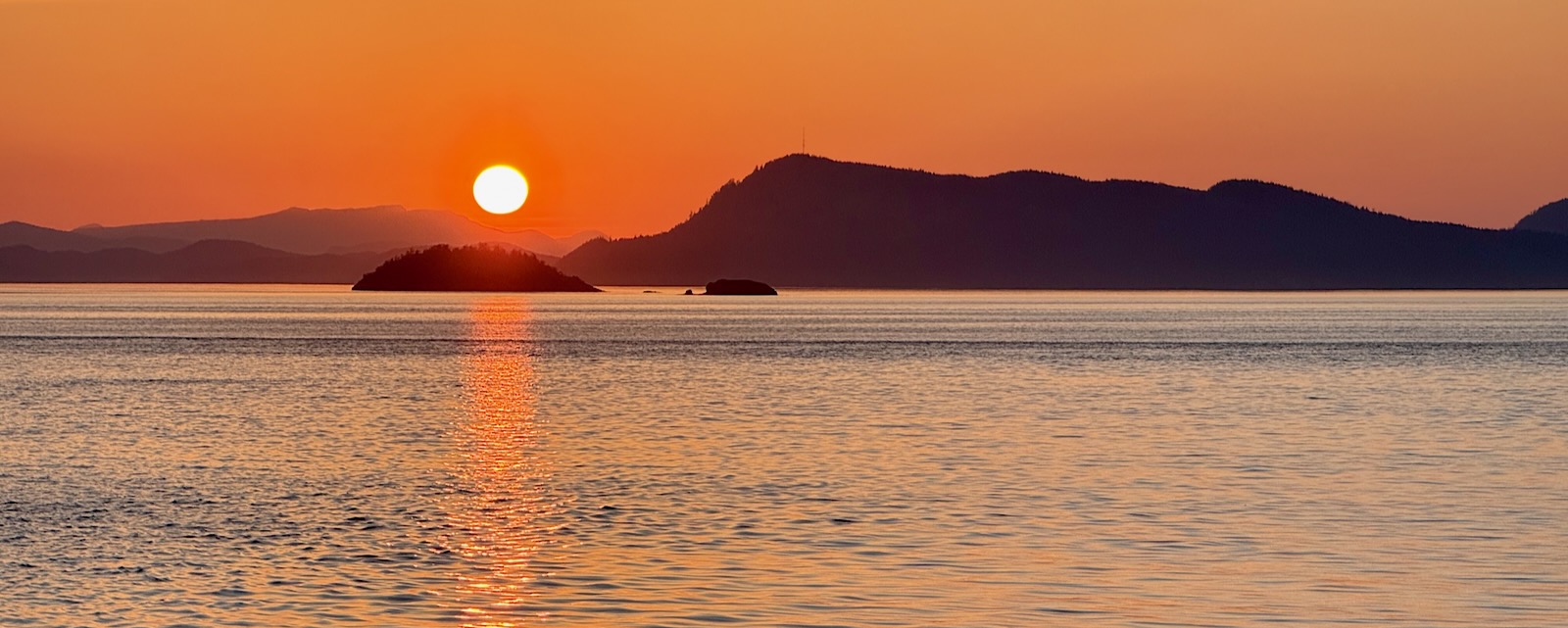 setting sun over islands and water