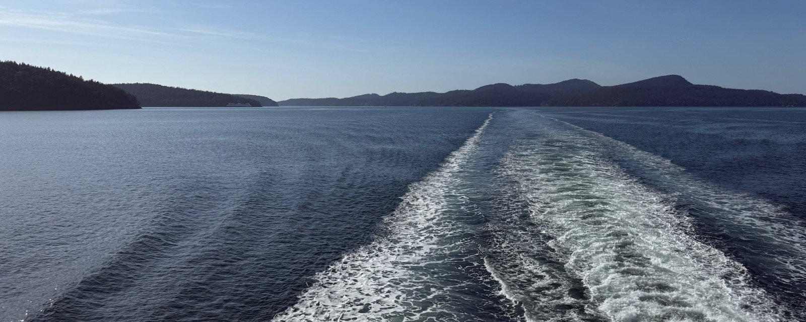 boat wake, islands in distance