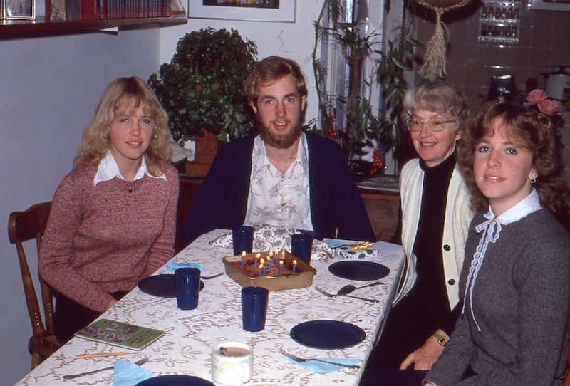 Larry with lit birthday cake